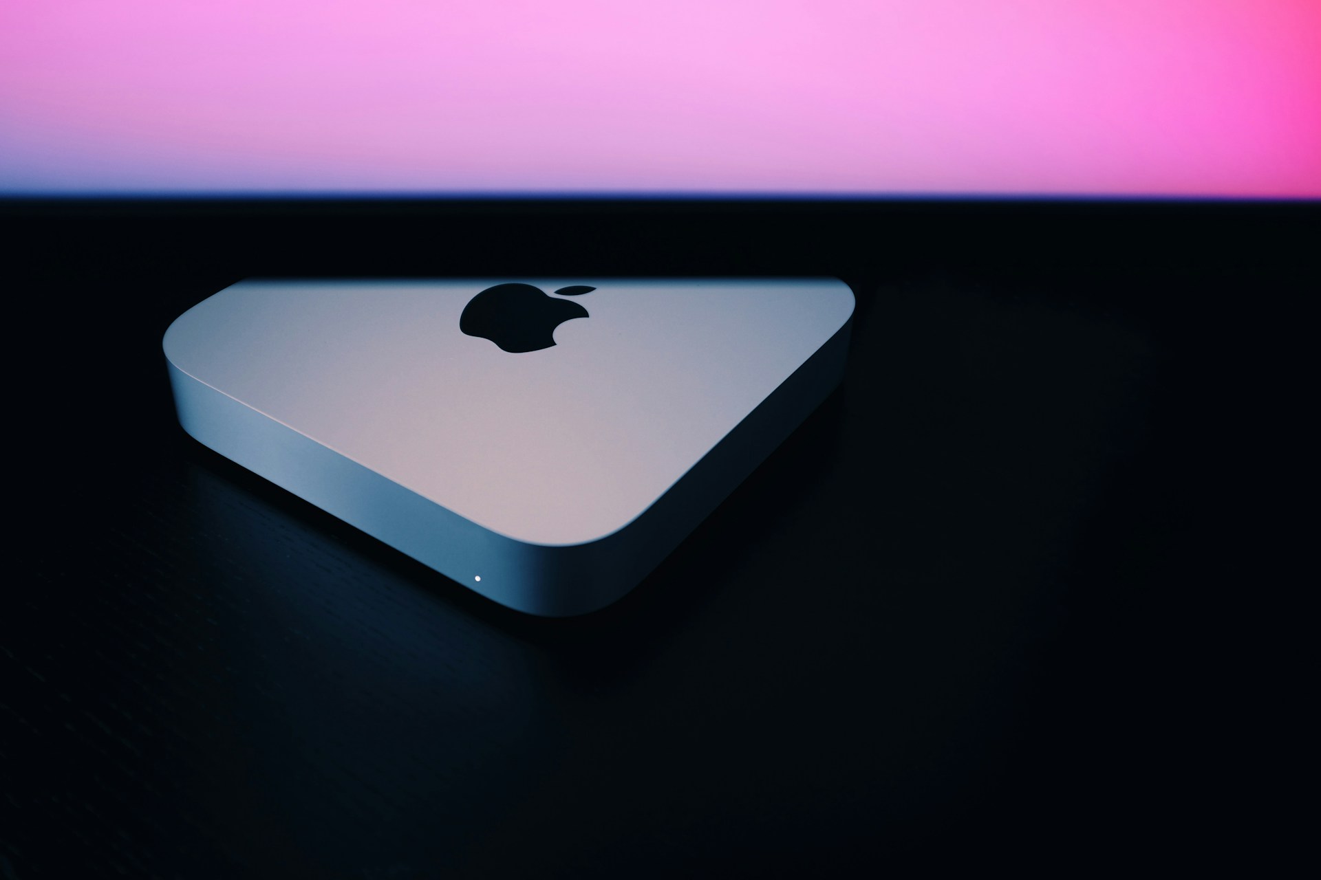 An Apple Mac Mini sits on a desk.