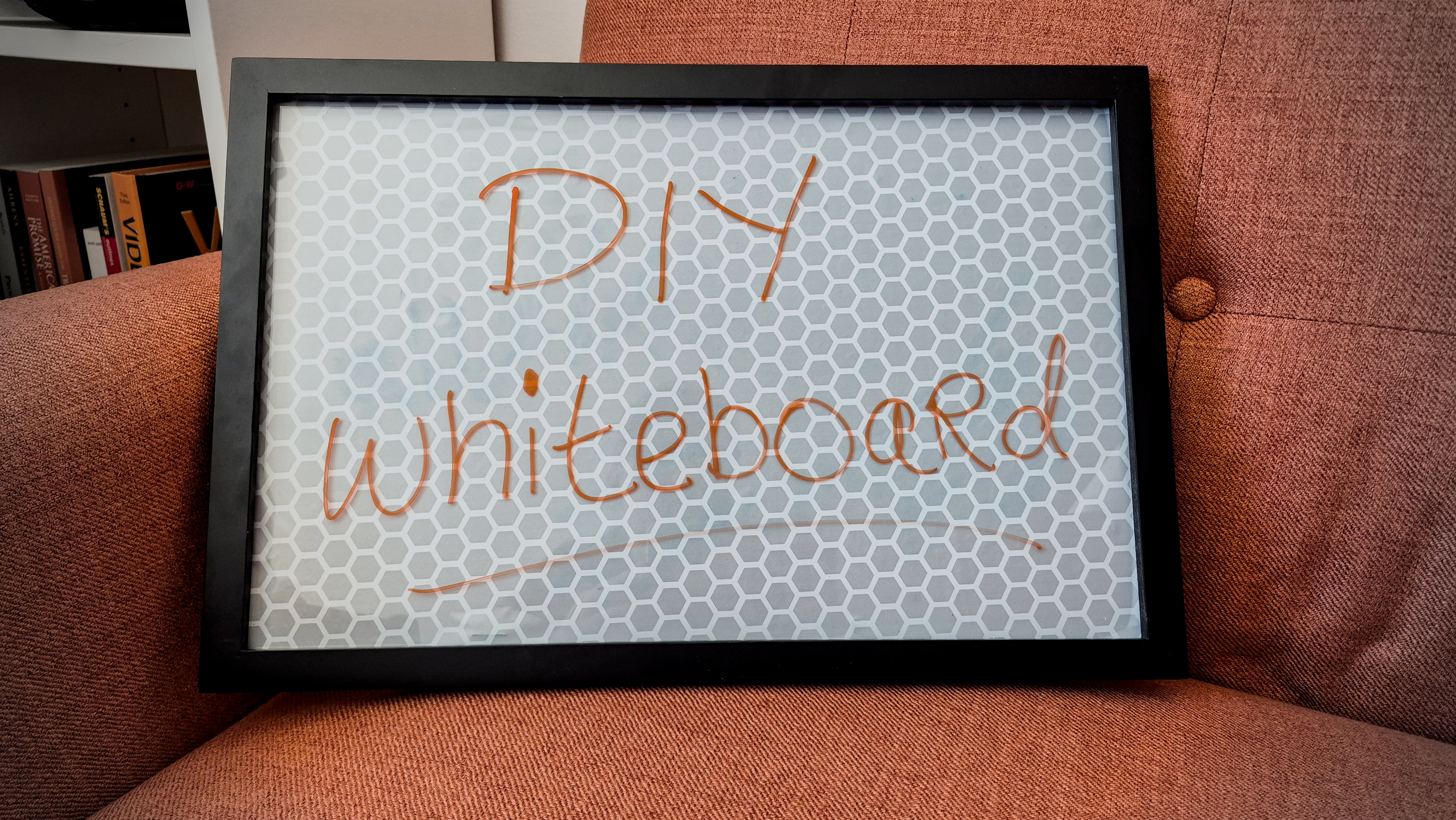 A small homemade whiteboard that reads “DIY whiteboard” on it.